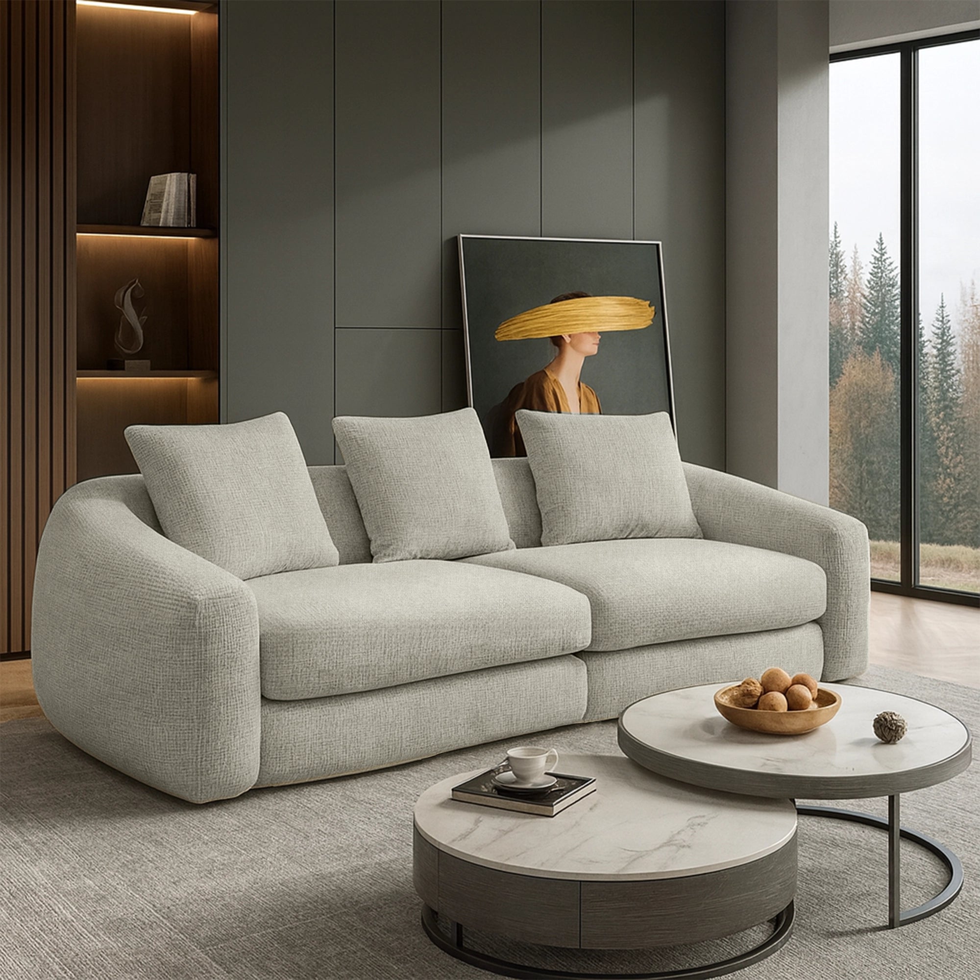 Modern living room with a gray sofa, round coffee tables, and a decorative wall piece.