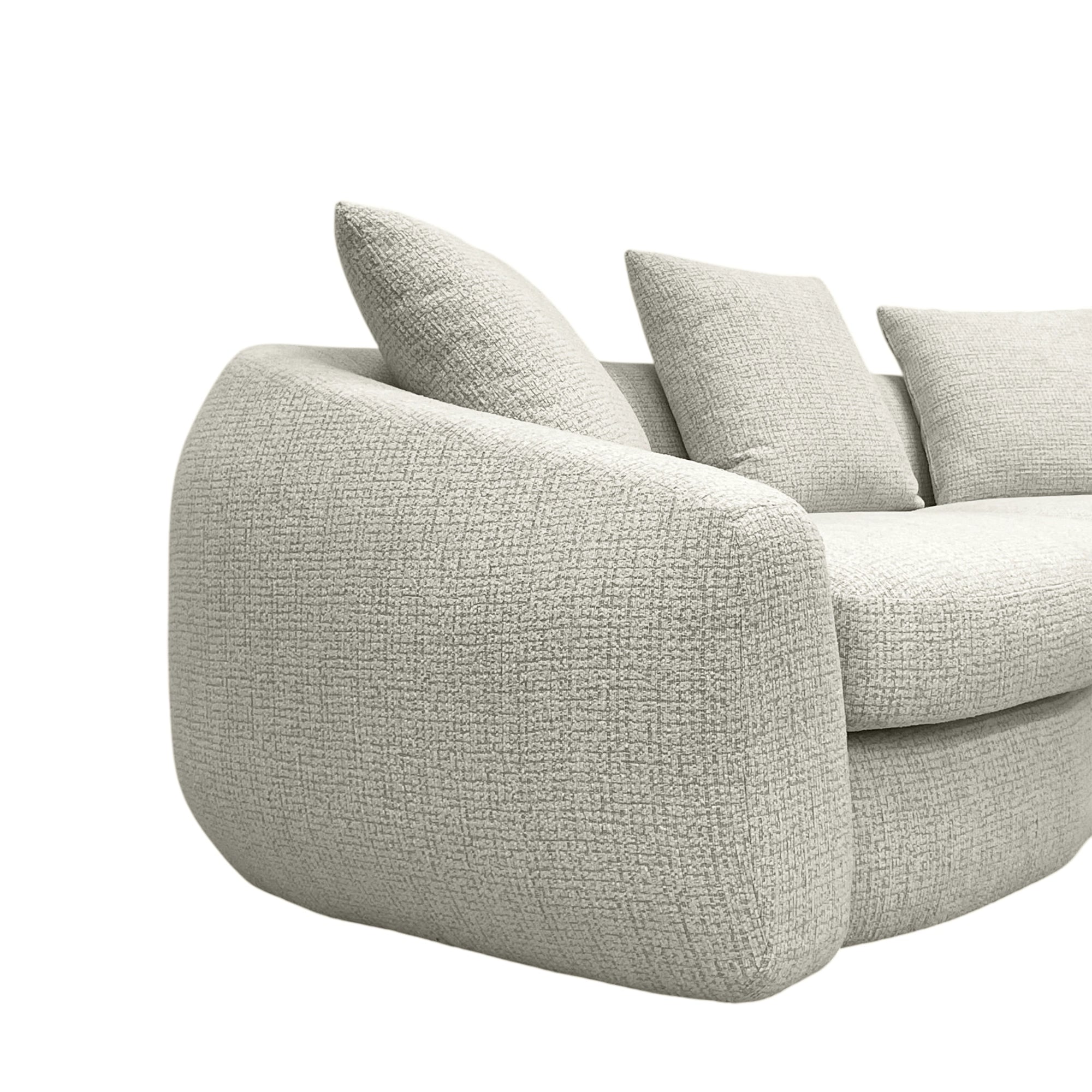 Beige textured sofa with cushions on a white background